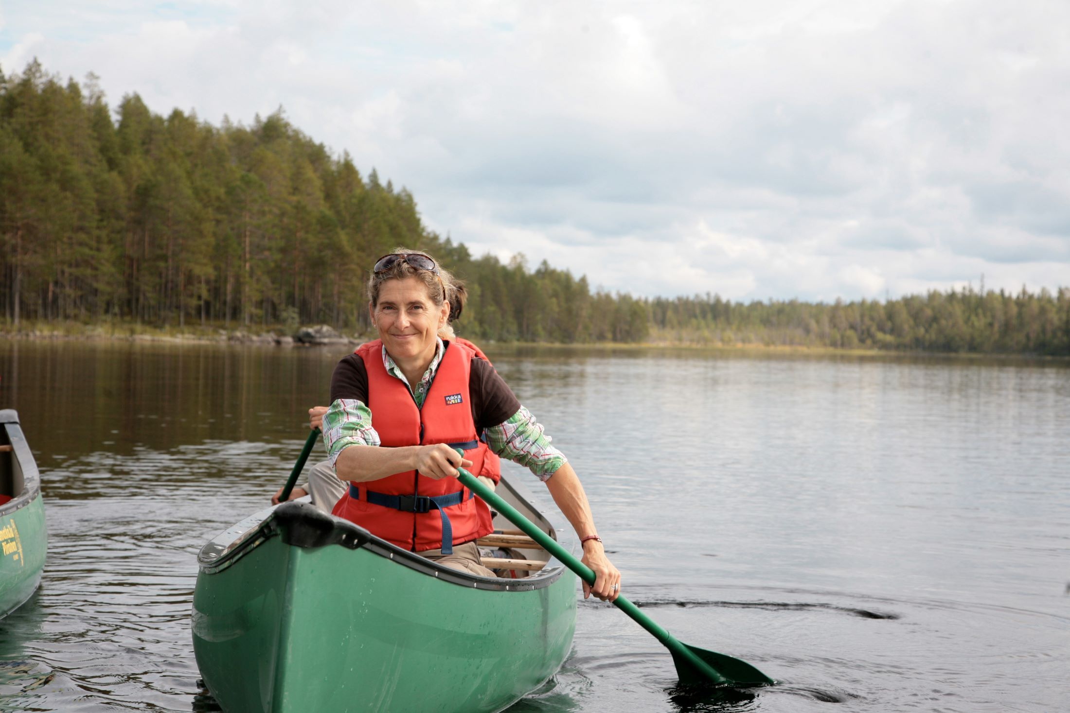 A woman canoeing on a calm lake