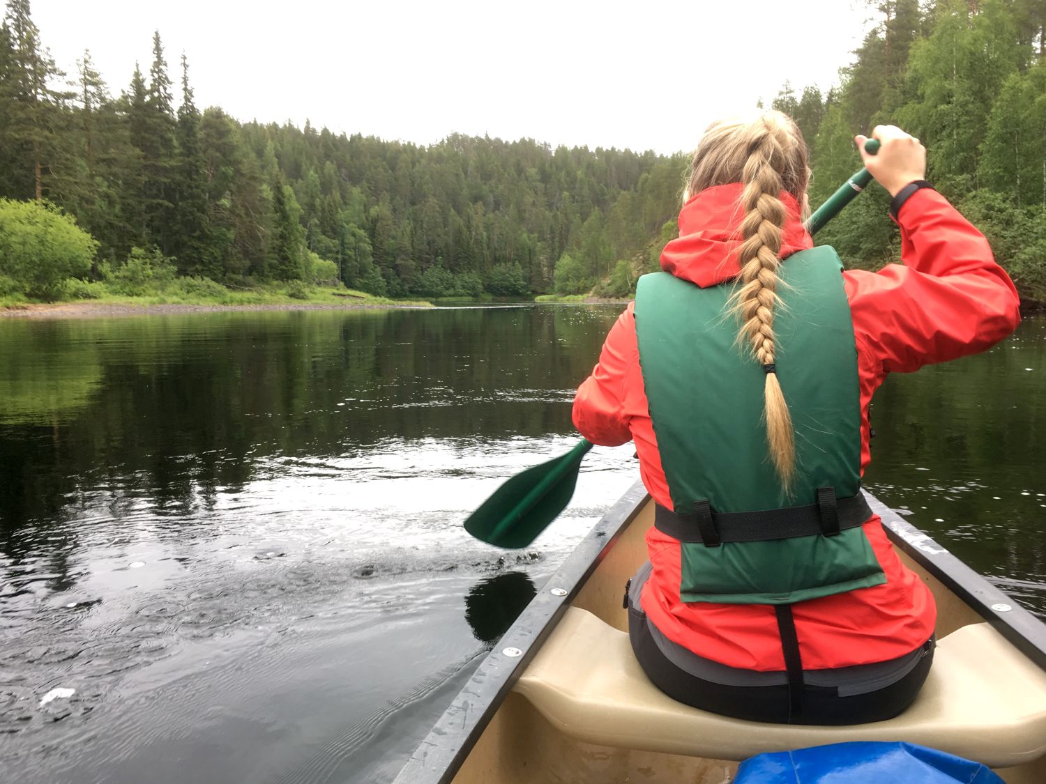 A woman canoeing on an open Indian canoe